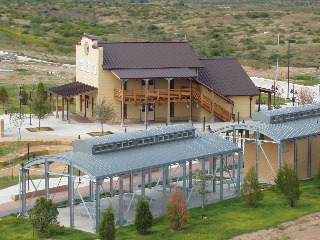 The stylized locomotive in the foreground serving as restrooms and a picnic arbor