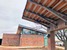The building's layered concrete walls continue the colorful earth in the cayon behind the facility